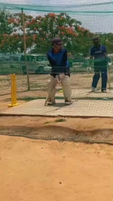 A session in the nets beneath a flowering flame tree